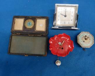 Lot 284. Four clocks for parts or repair.[ The large rectangular clock and the small round brass clock are Lux clocks. The others are unidentified