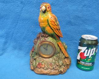Lot 283. Lux wood and plaster painted parrot clock. Movement works but hands don't move.