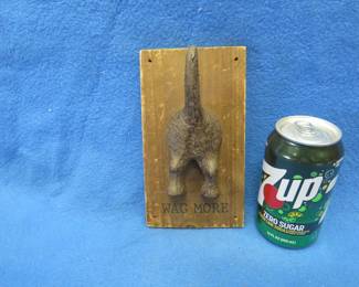 Lot 279. Cast iron south end of a dog going north on a wooden plaque