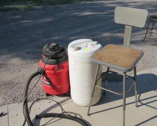 Lot 312. Genie 1.5-gallon shop vacuum, plastic container, and a shop stool