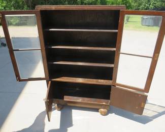 Lot 19. Two door free standing bookcase with beveled glass and lower storage area. 56" x 36" x 11"