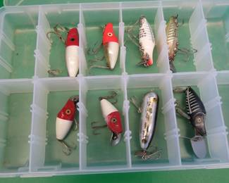 Lot 32. Eight Heddon Baits and a bait box, including River Runts, Midget Digits, and a Torpedo-style bait from Cordell