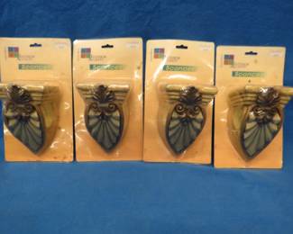Lot 104. Four new-in-the-package sconces