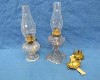 Lot 107. Two kerosene lamps with shades and two extra burners