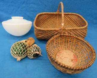 Lot 101. Two wicker baskets, a glass shade, and glass ball fishing floats.
