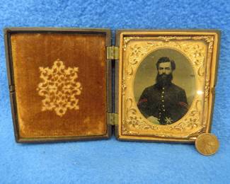Lot 14. Civil-War-era tintype in a military-themed case. Very good condition. Hand-colored photo of a soldier in the 2nd Division Artillery Corp