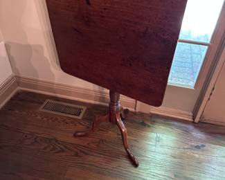 Antique mahogany tilt top table with antique butterfly repair on reverse of top.