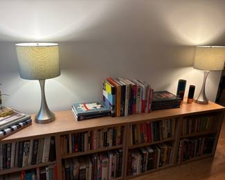 Extensive collection of books and bookcases, and lamps