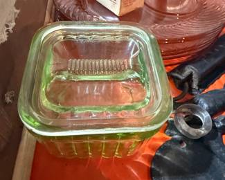 Vintage uranium/Depression glass lot: green butter dish with lid and two pink plates. Also includes a retro cough medicine box.