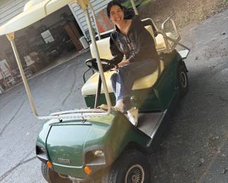 Yamaha 4 person gas golf cart with cover included. Aunt Bee in the drivers seat.