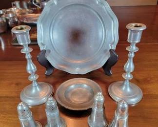 Pewter plates, candlesticks, salt and peppers