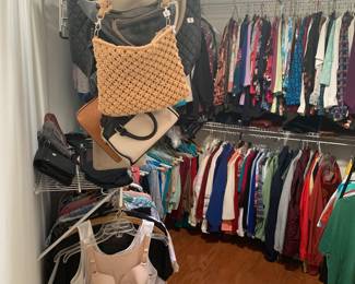 Full closet of male and female clothes, purses, hats and more