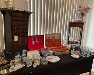 Asian style small cabinet, two plated Silver silverware sets, individual plated Silverware pieces, collectable perfume bottles