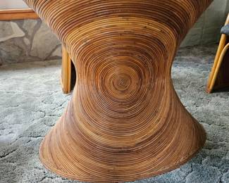 Side view of the sculptural bentwood table base with hourglass shape, composed of concentric laminated wood rings.