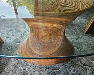 Mid-century modern coffee table featuring a sculptural, spiraling laminated wood base topped with a round glass surface.