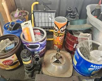 Assorted paint cans, buckets and shop supplies including a metal funnel, oil can and other containers.