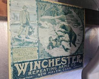 Vintage Winchester Repeating Arms tin sign or ammo box cover featuring a hunting dog and ducks illustration, green and white graphic.