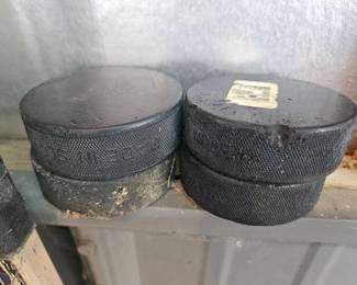Two stacked cast iron Dutch oven camping pots with lids, blackened from use.