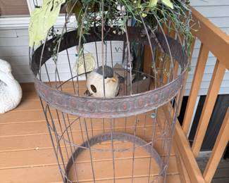 This is a beautiful really cool metal bird cage with a bird inside. It stands about 3 1/2 feet tall.