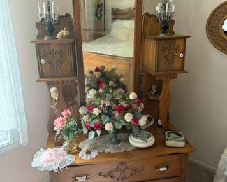 This is from our first walk through of the home. The front bedroom has a three-piece Victorian bedroom set. All three pieces were refinished by our client’s grand grandfather, and they are absolutely stunning. This is a lovely tall mirrored lay down dresser.