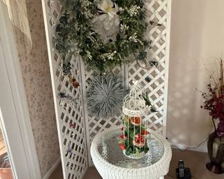 Another piece of wicker in excellent condition and a beautiful little trellis backdrop, covered with bird ornaments