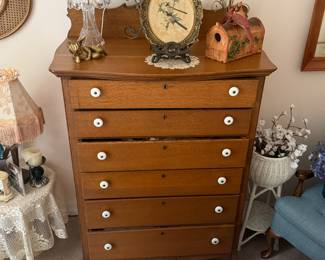 This is from our first walk through of the home. This is a beautiful tiger, oak dresser with porcelain pulls.