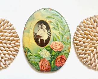 Natural Cowrie Shell Trivets & Antique Celluloid Tin Wall Hanging With Baby Portrait & Roses
Lot #: 107