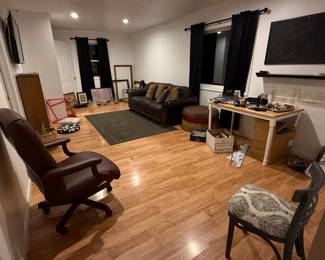 Rolling office chair, refinished chair, small kitchen table / desk, couch, bookshelf, ottoman, various wall prints and frames, 