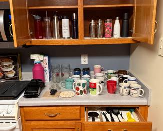 Various water bottles, coffee cups, utensils