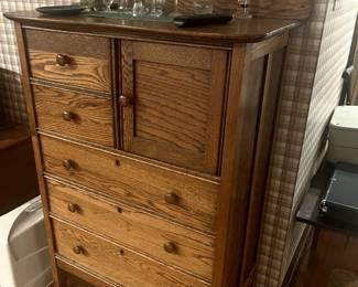 Antique tiger oak tall boy dresser with floating mirror, glassware