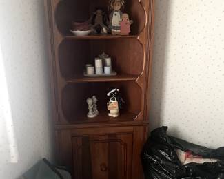 Oak corner cabinet, collectible items, bedspreads, blankets, linens.