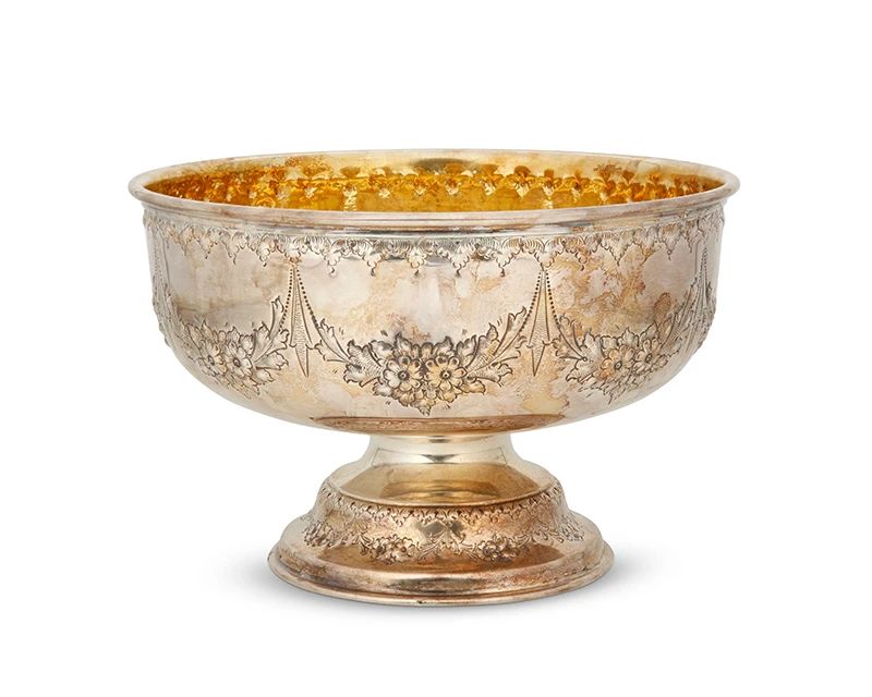 1001
An English sterling silver footed bowl
19th/early 20th century
With indistinct hallmarks and maker's mark: TW
With a gilt interior, decorated with repoussé floral swags
6" H x 9.5" Dia.
22.2 oz. troy approximately
Estimate: $400 - $600