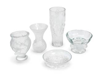 1239
A group of Lalique clear and frosted glass table items
Late 20th/early 21st century
Each etched to underside: Lalique ® France [post-1978]
Comprising a flared 'Arabesque' vase with vinery decoration (5.25" H x 3.5" Dia.), a flared ‘Elves' vase with lily-of-the-valley decoration (8" H x 3.25" Dia.), a 'Nogent' footed dish with four sparrows supporting the bowl (3.375" H x 5" Dia.), a 'Rosine' footed vase decorated with a pair of doves (5" H x 4" W x 4" D), and a dish with aster decoration (1.5" H x 5.5" Dia.)
5 pieces
Estimate: $400 - $600