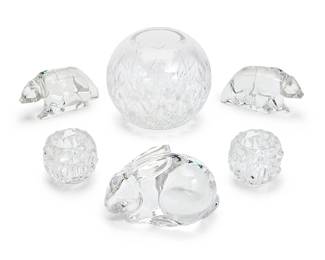 1268
A group of Tiffany & Co. glass table items
Late 20th/early 21st century
Most with Tiffany & Co. stencil mark; one with stencil mark: Val St. Lambert © De Sousa
Comprising a pair of 'Rock Cut' glass votives (2.875" H x 3.5" Dia.), a bulbous cut glass vase (6.5" H x 7.5" Dia.), and a pair of glass figures of bears (3.25" H x 6.25" W x 2.25" D), together with a Val Saint Lambert glass figure of a rabbit (4.5" H x 6.5" W x 4" D)
6 pieces
Estimate: $500 - $700