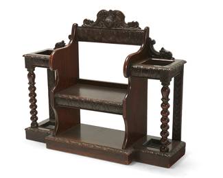 1252
A Victorian carved oak hall stand
Mid/late 19th century
Decorated with palmettes and two stylized dolphin fish, with egg and dart molding and twisted stem supports, and metal trays inset into the bottom on each side
38" H x 47" W x 12" D
Estimate: $700 - $900