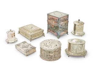 1010
A group of silver-plated boxes and biscuit barrels
20th century
Most variously marked for maker
Comprising 3 footed biscuit barrels including two with a hinged lid and attached stand, one with chased fern and ivy motifs and ball and claw feet, and one with scalloped edges and a glass liner, a pierced hinged box with two handles and locking mechanism, and a group of three silver-plated hinged boxes including one round, one in the form of a book, and one rectangular
7 pieces
Largest biscuit barrel: 6.75" H x 9" W x 6.5" D; Pierced box: 11" H x 8.75" W x 8" D
Estimate: $300 - $400