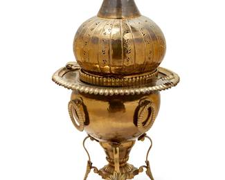 1233
A Middle Eastern brass brazier
Early 20th century
Of typical form, with pierced onion-shaped cover, over a circular stand with four fluted handles
on a scrolling base with flaring legs
46" H x 24" Dia.
Estimate: $300 - $500