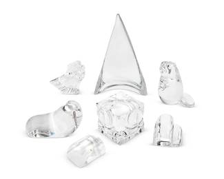 1274
A group of Steuben glass table decorations
Late 20th/early 21st century
Most marked for Steuben
Comprising a sculpted glass cube 'Passage' paperweight designed by Peter Aldridge (4" H x 4" W x 4" D), an 'American Eagle' figure designed by Donald Pollard (5.5" H x 4.5" W x 5" D), a figure of a walrus with one sterling silver tusk designed by Paul Schulze (4.5" H x 4" W x 7.5" D), a figure of a beaver with garnet eyes designed by Lloyd Atkins (8" H x 5" W x 5" D), and a pair of 'Paired Hearts' designed by James Carpenter (Larger: 3.75" H x 4" W x 1.75" D), together with an unmarked glass sail (12" H x 8" W x 3.5" D)
7 pieces
Estimate: $200 - $300