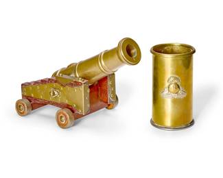 1163
A brass shell casing and model cannon
19th/20th century
The shell with applied crest for The Lancashire Fusiliers, together with a miniature brass articulated cannon on a brass-mounted wood base with applied armorial
2 pieces
Shell: 6" H x 3.375" Dia.; Canon: 4.75" H x 10.5" W x 6.5" D
Estimate: $200 - $300