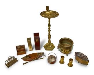 1168
A group of brass and wood table items
20th century
Comprising a brass-mounted oak model of a row boat, possibly a desk set with inkwell holders, a Bombay Company wood match holder with lion's head ring handles, a brass match holder, a silver plate-mounted oak biscuit barrel, a turned brass ashtray stand, two letter racks, a pair of brass spill vases, a pierced brass basket, and a brass jardinière with lion head ring handles
11 pieces
Boat: 3.25" H x 14.5" W x 4.5" D; Taller match holder: 12.5" H; Ashtray stand: 28.5" H x 10.75" Dia.
Estimate: $300 - $500