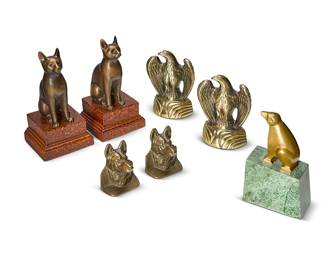 1174
A group of figural bookends
Mid/late 20th/early 21st century
Comprising a pair of brass eagle figure bookends (7.5" H), a pair of bronze cat figure bookends on faux burlwood composite bases (10.25" H), a single brass polar bear figure on green marble base (8.5" H), and a pair of German Shepherd heads (4" H)
7 pieces
Estimate: $100 - $200