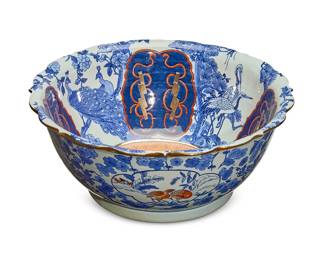 1300
A Chinese porcelain punch bowl
Mid-20th century; Hong Kong
With Chinese characters stamped in red to underside
Decorated with cranes, peacocks, blossoms, lightning, and cloud motifs
7" H x 16.5" Dia.
Estimate: $200 - $300