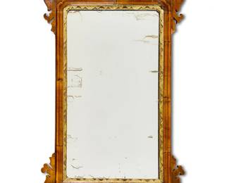 1286
A George II parcel-gilt mahogany mirror
18th century
With pierced foliate crest, eared corners, and gilt inner border
34" H x 19.5" W x 2.375" D
Estimate: $200 - $300