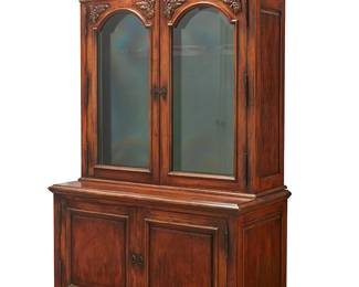 1105
A Victorian-style stained wood gun cabinet
20th century
The top with beveled glass doors, the interior converted to a space for nine guns behind locking glass inner doors, the base with two cupboard doors opening to reveal eight drawers later updated and the top fitted with covers
93" H x 59" W x 28.5" D
Estimate: $700 - $900