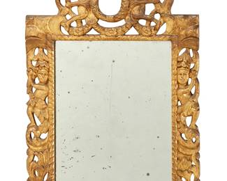 1029
A Charles II style carved giltwood wall mirror
19th century
The carved wood frame surmounted by two putti holding a laurel leaf crest over two carved figures flanking the rectangular mirror
35" H x 24" W
Estimate: $1,000 - $1,500