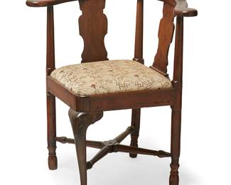 1145
A Queen Anne style walnut corner armchair
19th century
The chair with double fiddle-back below a horseshoe crest rail, raised on legs joined by a turned X-stretcher, with Asian-style taupe upholstered seat
23.5" H x 22" W x 22" D
Estimate: $200 - $300