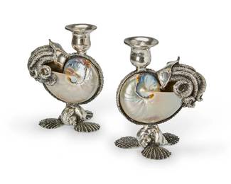 1266
A pair of Lazaro Diaz metal-mounted nautilus shell candlesticks
1994
Each signed, dated, and inscribed: Lazaro / NY / 94
Each shell mounted with tentacle-form metal and raised on three scallop shell-form feet
2 pieces
Each: 6.5" H
Estimate: $300 - $500