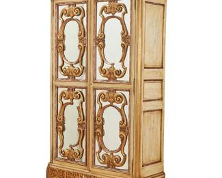 1140
A Venetian giltwood and mirror-mounted wardrobe
Early 20th century with later additions
The top frieze with carved seraphim at the corners and acanthus designs in the center, with scrolled front feet and block rear feet, the mirrored cabinet doors opening to reveal five shelves of labeled compartments above two open drawers
88" H x 50" W x 20" D
Estimate: $800 - $1,200