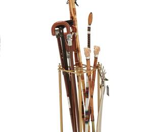 1047
A brass cane stand and group of walking implements
20th century
Comprising a carved wood walking stick with beaded decoration, a portable seat stand/walking cane with leather seat sling, three metal canes, and two bamboo canes, all housed in a brass and iron umbrella/cane stand, together with two wood shoehorns with composite dog head handles and a metal shoehorn with a stag's head handle,
11 pieces
The longest: 48.5" L; Stand: 25.5" H x 8" W x 8" D
Estimate: $200 - $300
