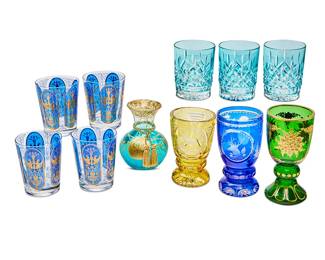 1323
A group of tinted glassware items
20th/early 21st century
Aqua glasses with Waterford factory marks; vase signed: Diana Taikagna
Comprising a set of 3 Waterford aqua cut glass double old-fashioned glasses (4.5" H), a set of 4 double old-fashioned glasses with blue and gilt decoration (4.5" H), a gilt-decorated green glass footed goblet (7" H), a blue cut-to-clear glass footed goblet with images of stags and fowl, an amber cut-to-clear glass footed goblet with images of ducks and deer, and a gilt-decorated turquoise glass vase
11 pieces
Estimate: $100 - $150